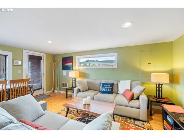 a living room with furniture and a lamp