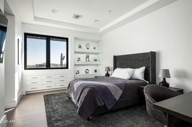 a bedroom with a bed and a window