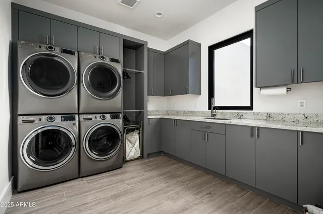 a utility room with sink dryer and washer