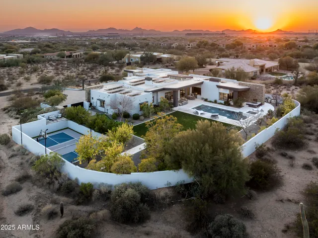 a view of a house with a mountain and a forest