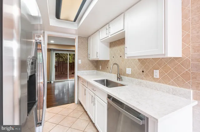 a kitchen with a sink and a refrigerator