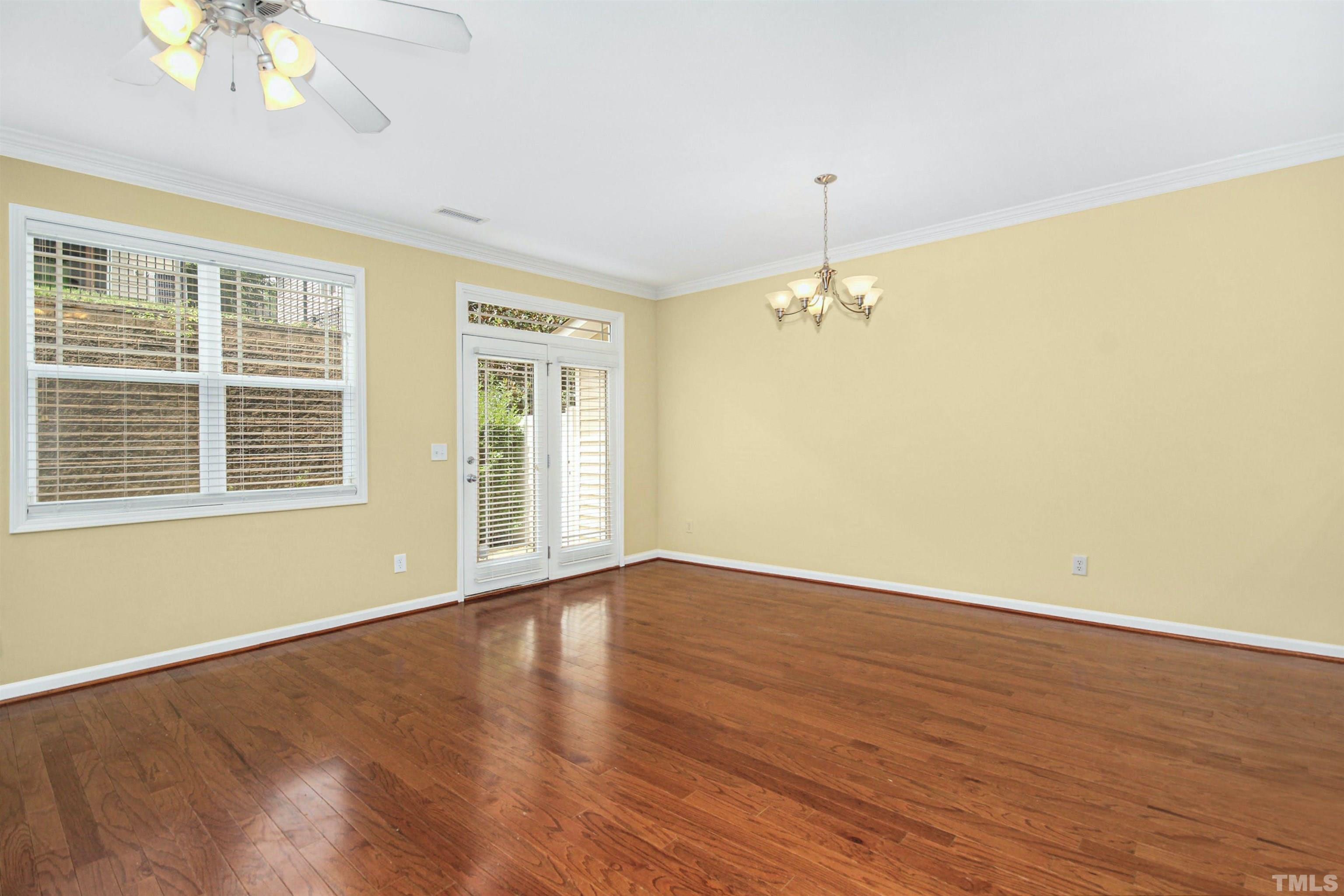 4611 Altha Street Raleigh, NC 27606 - Photo 4 of 19 a view of an empty room with a window and wooden floor