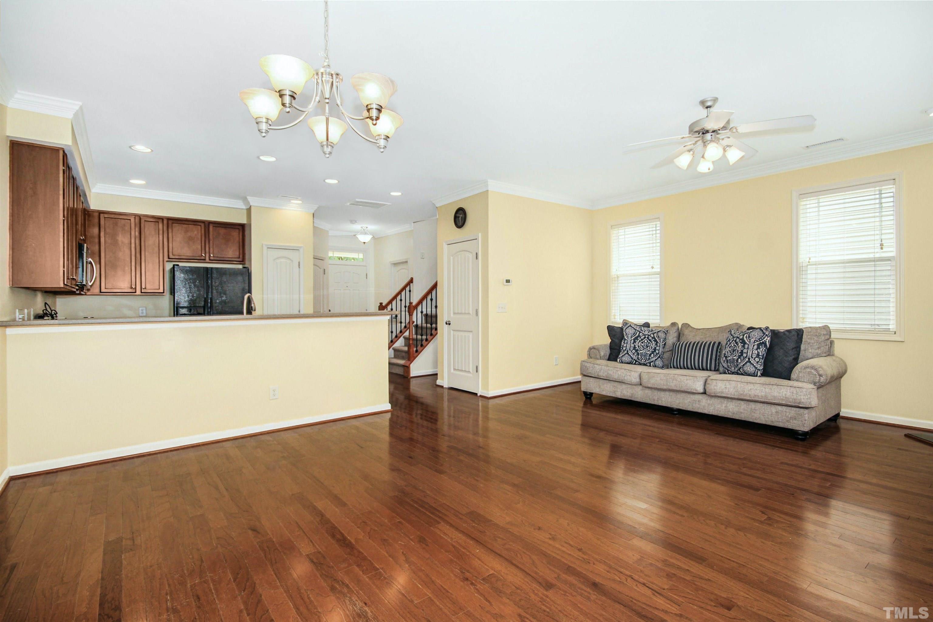 4611 Altha Street Raleigh, NC 27606 - Photo 5 of 19 a living room with stainless steel appliances kitchen island granite countertop furniture and a chandelier