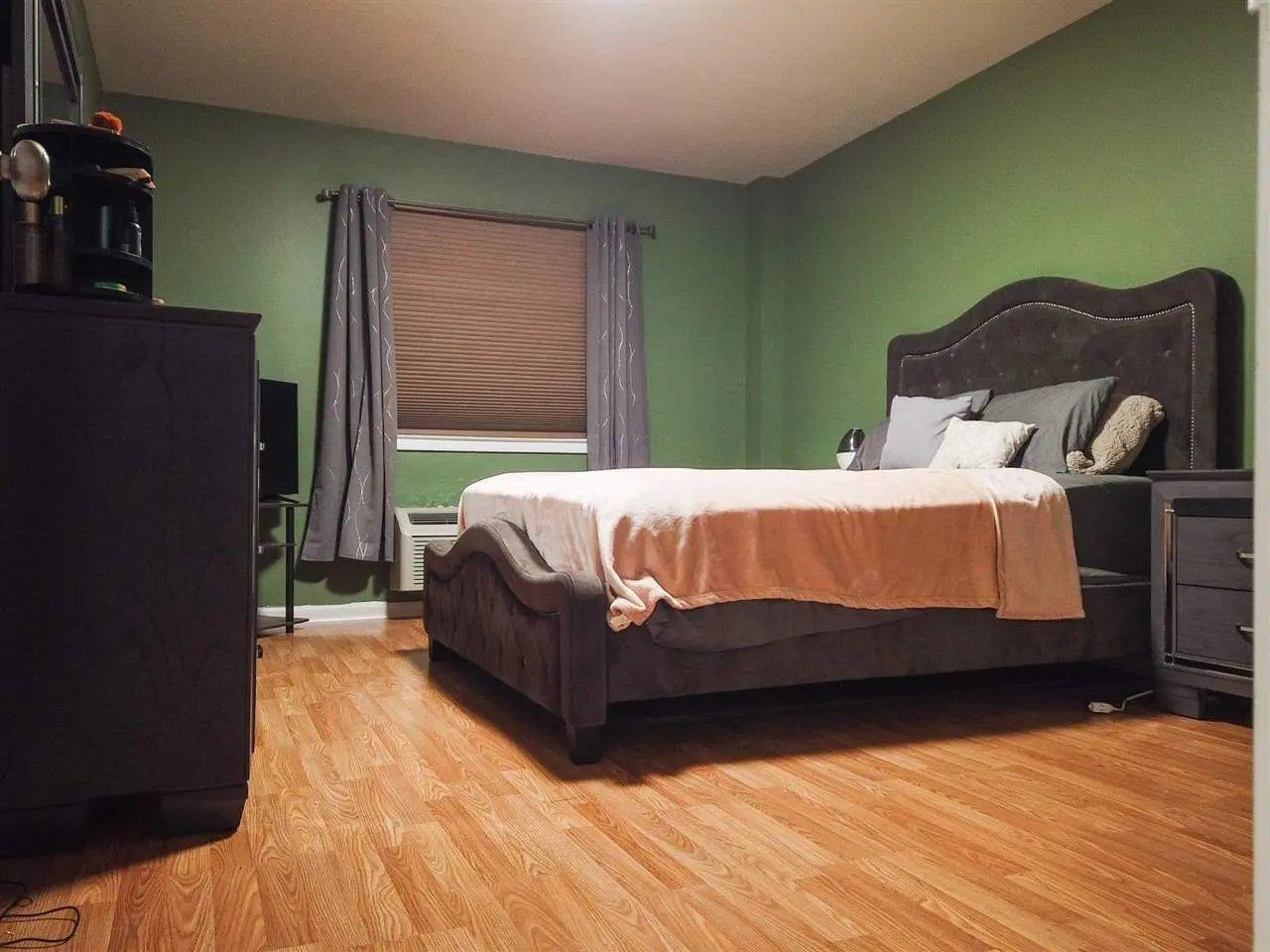 3900 Liberty Avenue, Unit 1B North Bergen, NJ 07047 - Photo 11 of 15 a bedroom with a bed and window