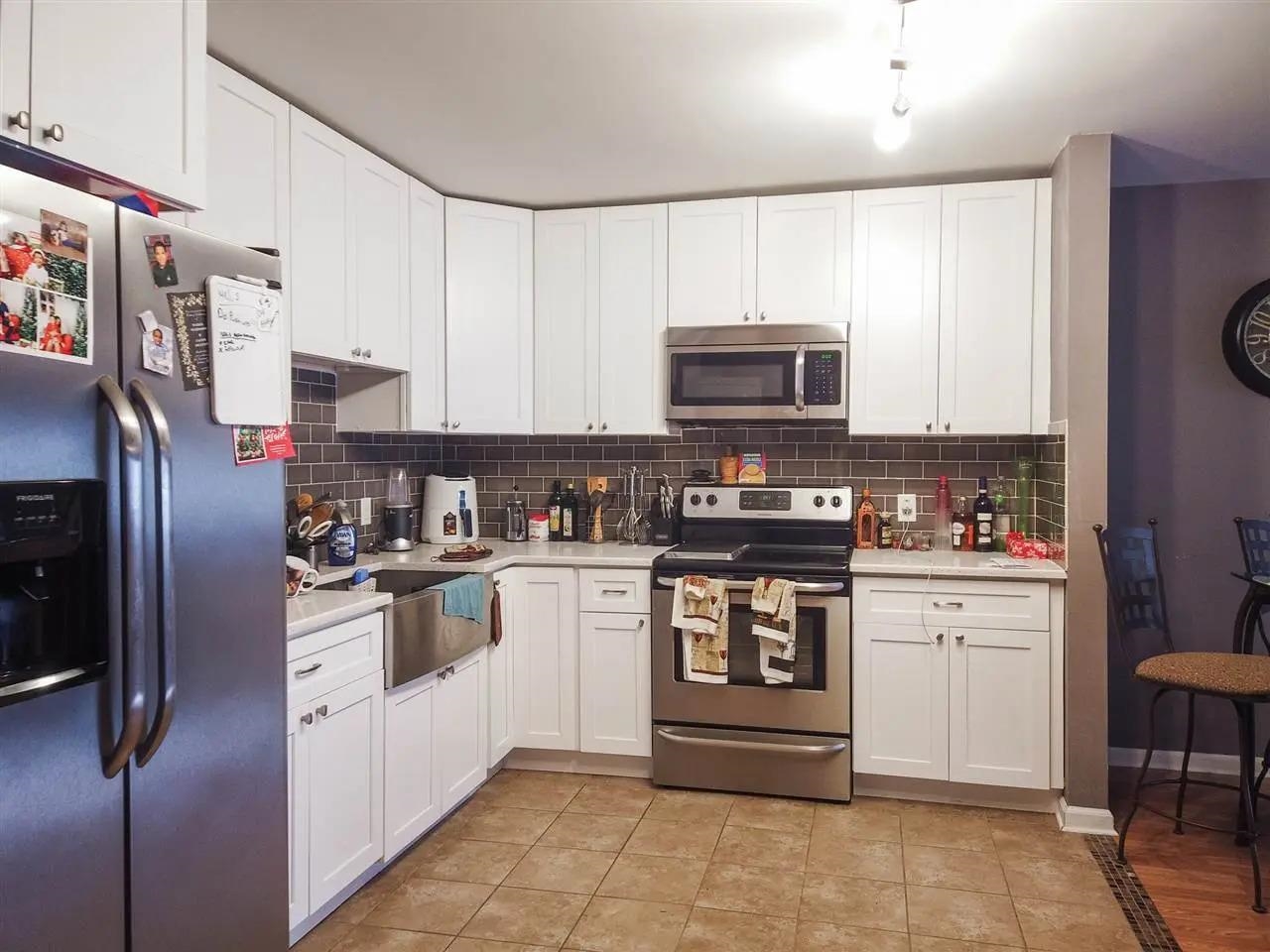 3900 Liberty Avenue, Unit 1B North Bergen, NJ 07047 - Photo 10 of 15 a kitchen with stainless steel appliances granite countertop a refrigerator stove and sink