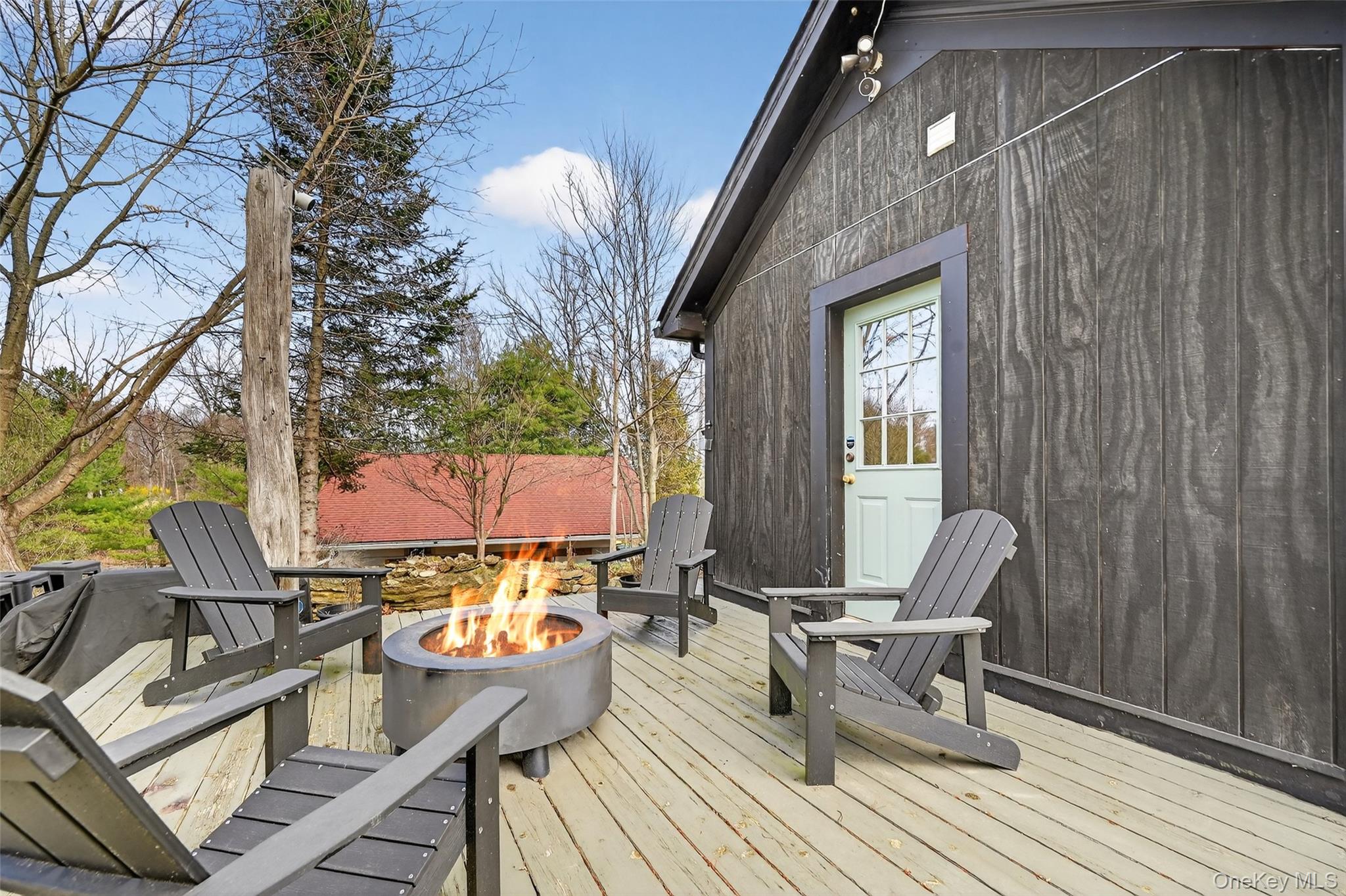 96 Lower Wisner Road Warwick, NY 10990 - Photo 29 of 34 Spacious outdoor deck featuring natural wood planks, a modern fire pit, and ample room for seating