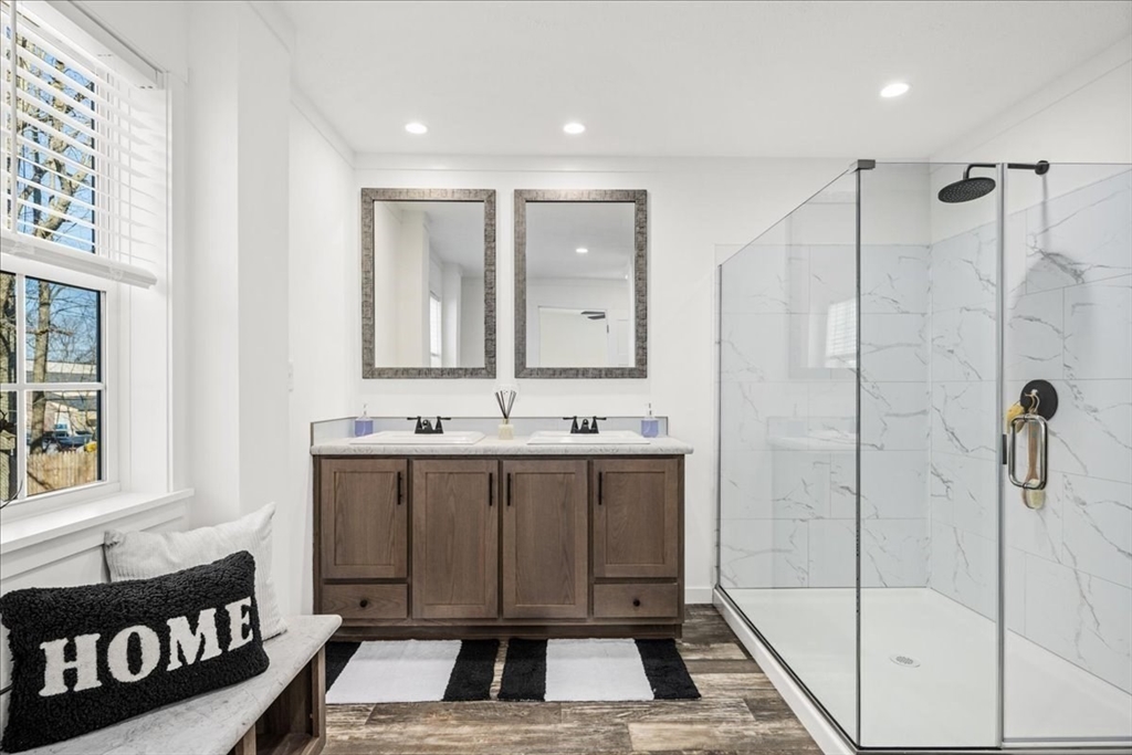 6 Berry Farms Road, Unit 63 Sturbridge, MA 01566 - Photo 11 of 17 a bathroom with a sink and a mirror