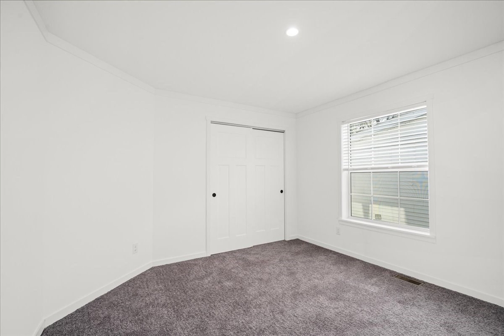 6 Berry Farms Road, Unit 63 Sturbridge, MA 01566 - Photo 14 of 17 a view of an empty room with a window