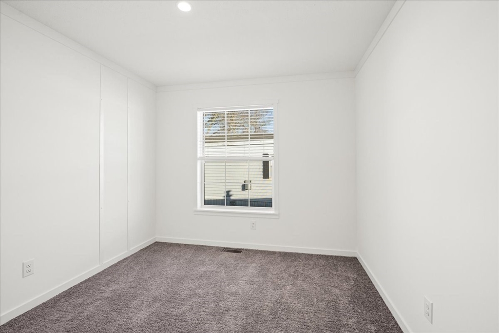 6 Berry Farms Road, Unit 63 Sturbridge, MA 01566 - Photo 15 of 17 an empty room with a window