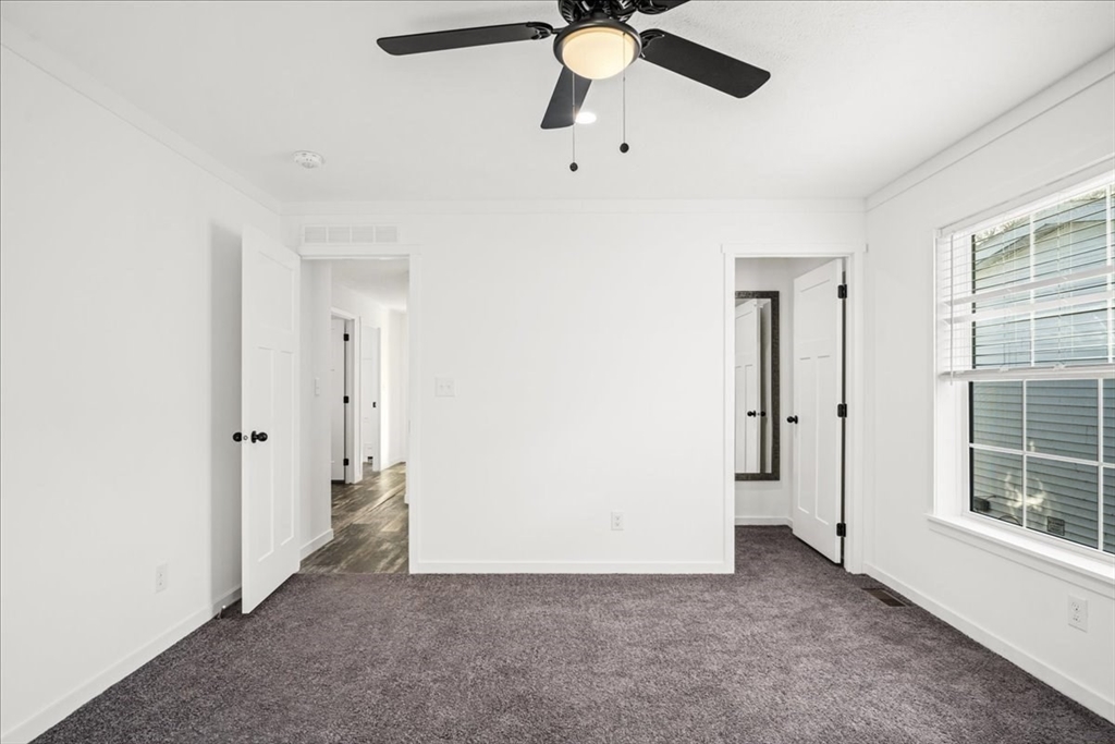 6 Berry Farms Road, Unit 63 Sturbridge, MA 01566 - Photo 10 of 17 wooden floor in an empty room with a window