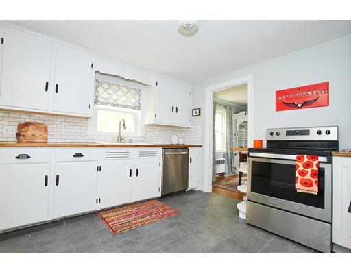 46 Stevens Road Melrose, MA 02176 - Photo 7 of 16 a kitchen with stainless steel appliances a stove and white cabinets