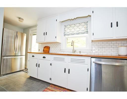 46 Stevens Road Melrose, MA 02176 - Photo 8 of 16 a kitchen with stainless steel appliances white cabinets a sink and a window