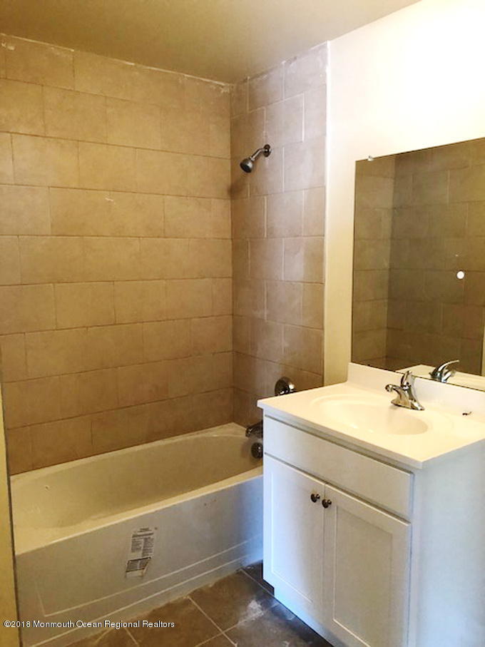 4 Abbey Road Tinton Falls, NJ 07753 - Photo 6 of 6 a bathroom with a sink and a bathtub