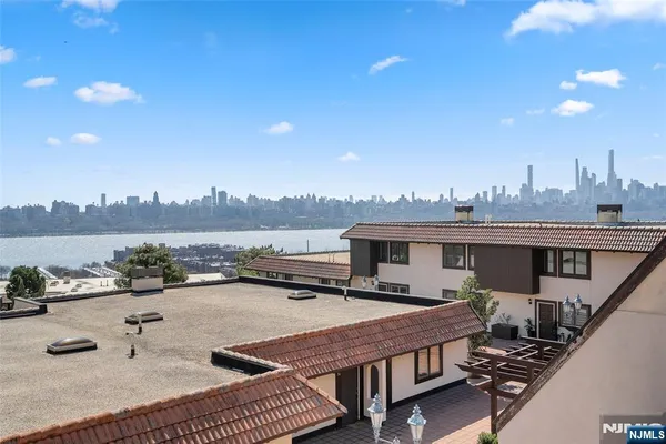 a view of a house with pool and chairs
