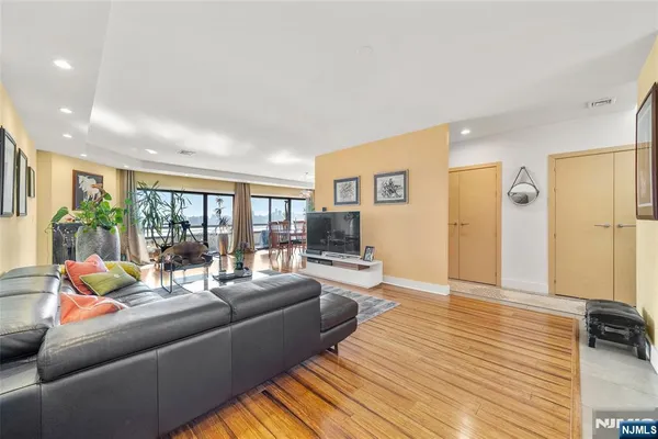 a dining room with wooden floor and large window