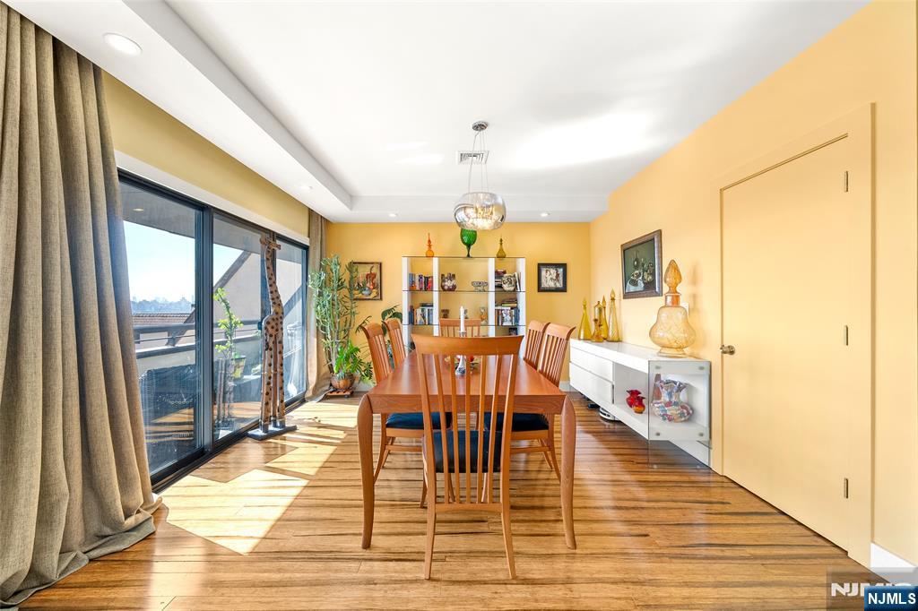 300 Gorge Road, Unit 58 Cliffside Park, NJ 07010 - Photo 14 of 32 a dining room with wooden floor and large window