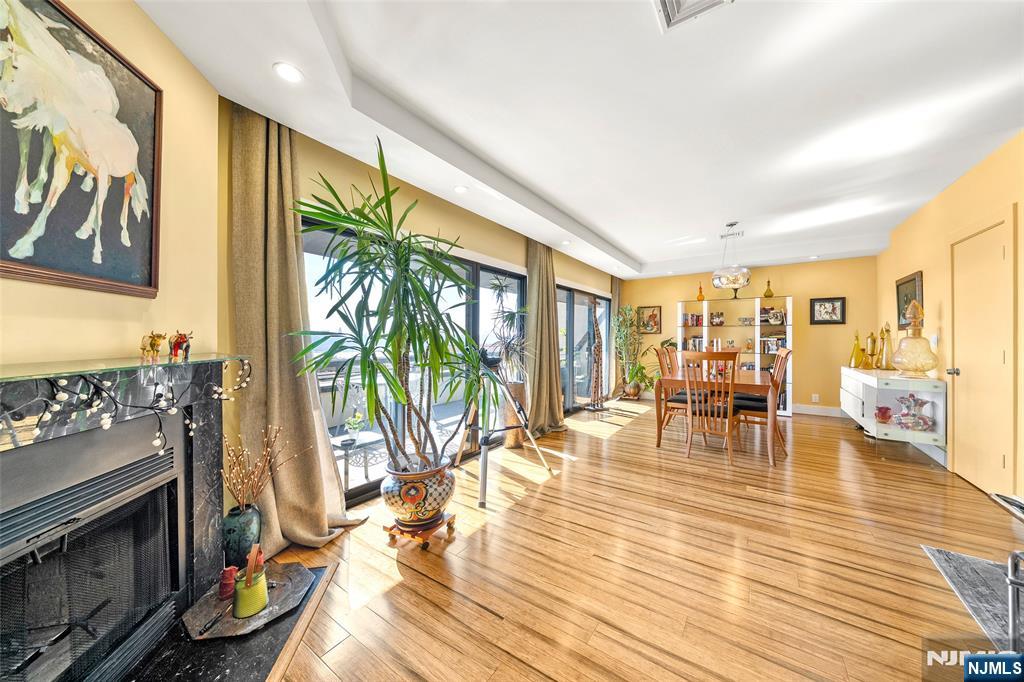 300 Gorge Road, Unit 58 Cliffside Park, NJ 07010 - Photo 15 of 32 a living room with furniture wooden floor and a fireplace