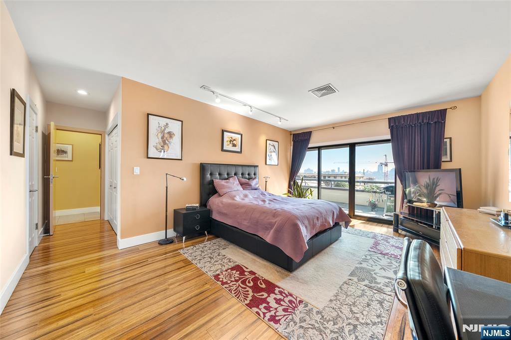 300 Gorge Road, Unit 58 Cliffside Park, NJ 07010 - Photo 20 of 32 a bedroom with a bed and glass walk in closet