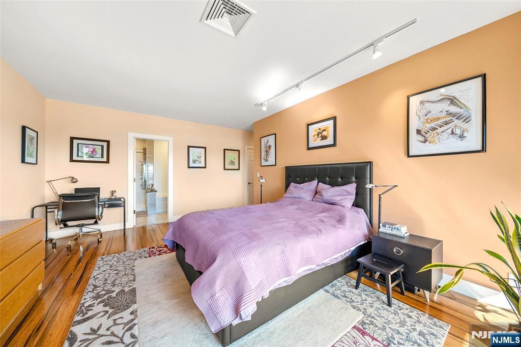 300 Gorge Road, Unit 58 Cliffside Park, NJ 07010 - Photo 21 of 32 a bedroom with a bed and wooden floor