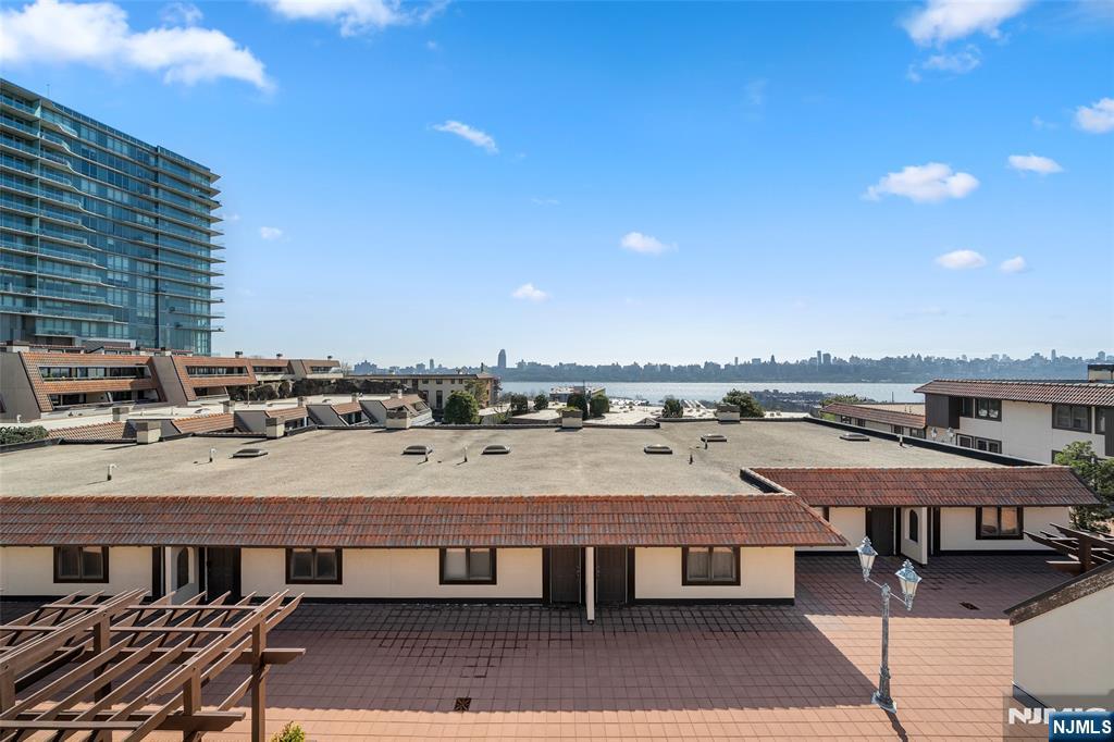 300 Gorge Road, Unit 58 Cliffside Park, NJ 07010 - Photo 25 of 32 a view of a balcony with a table and chairs