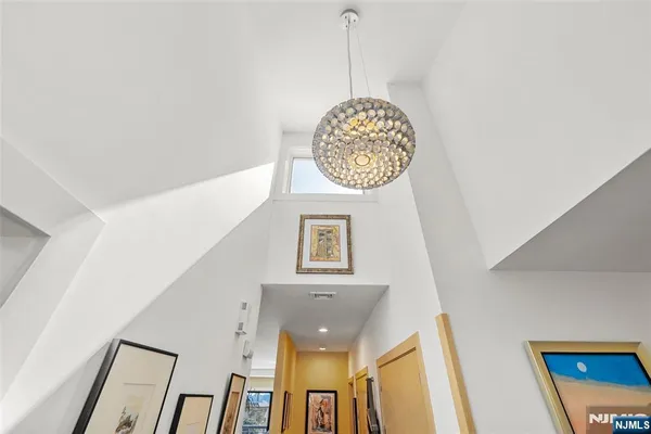 a kitchen with stainless steel appliances granite countertop a sink a stove a refrigerator cabinets and a dining table
