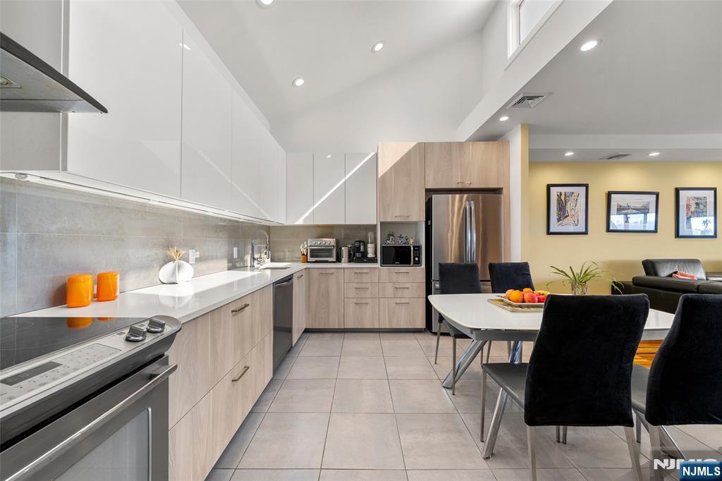 300 Gorge Road, Unit 58 Cliffside Park, NJ 07010 - Photo 9 of 32 a large kitchen with a table and chairs