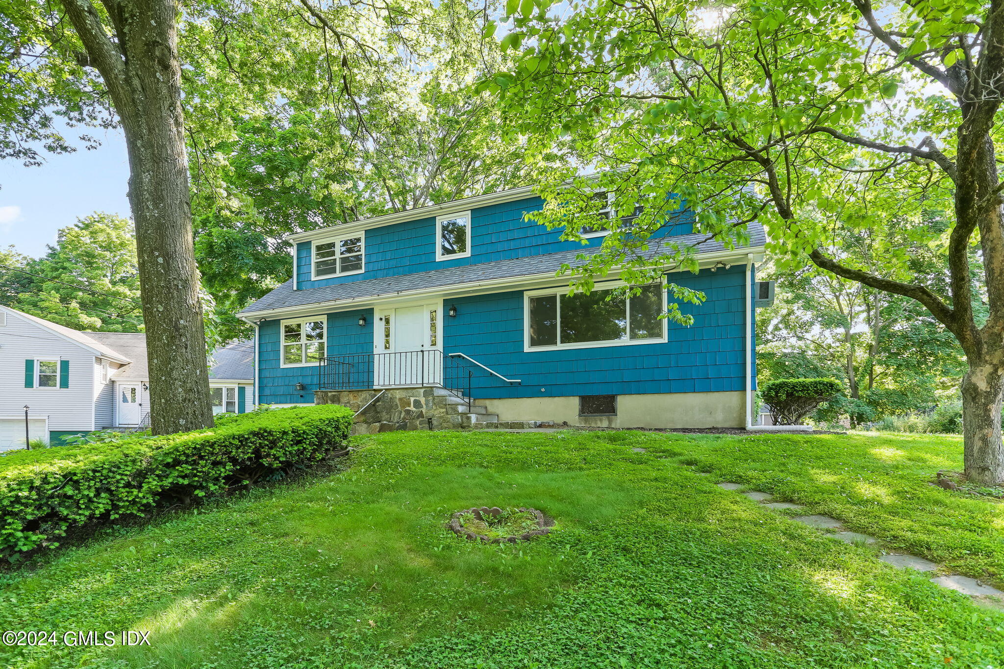 38 Maplewood Drive Cos Cob, CT 06807 - Photo 1 of 24 a front view of a house with a yard
