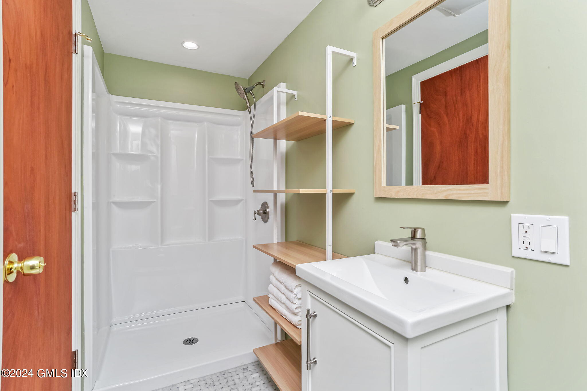 38 Maplewood Drive Cos Cob, CT 06807 - Photo 11 of 24 a bathroom with a sink a mirror and a shower