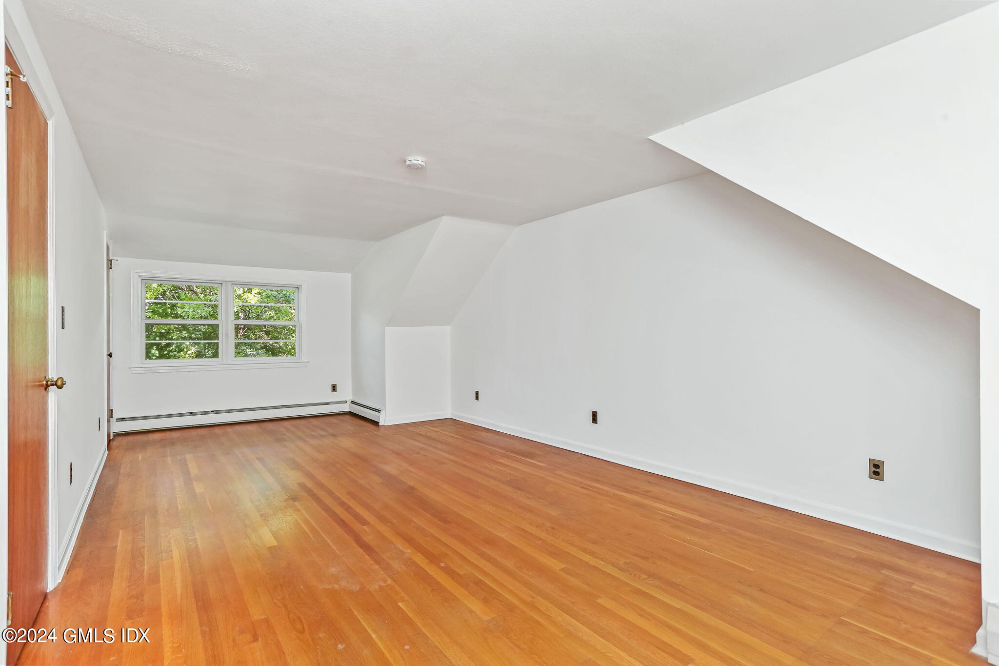 38 Maplewood Drive Cos Cob, CT 06807 - Photo 12 of 24 a view of an empty room with wooden floor and a window