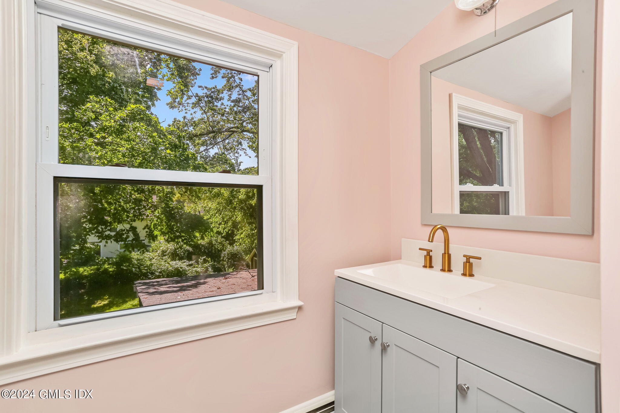 38 Maplewood Drive Cos Cob, CT 06807 - Photo 14 of 24 a bathroom with a sink mirror and a window