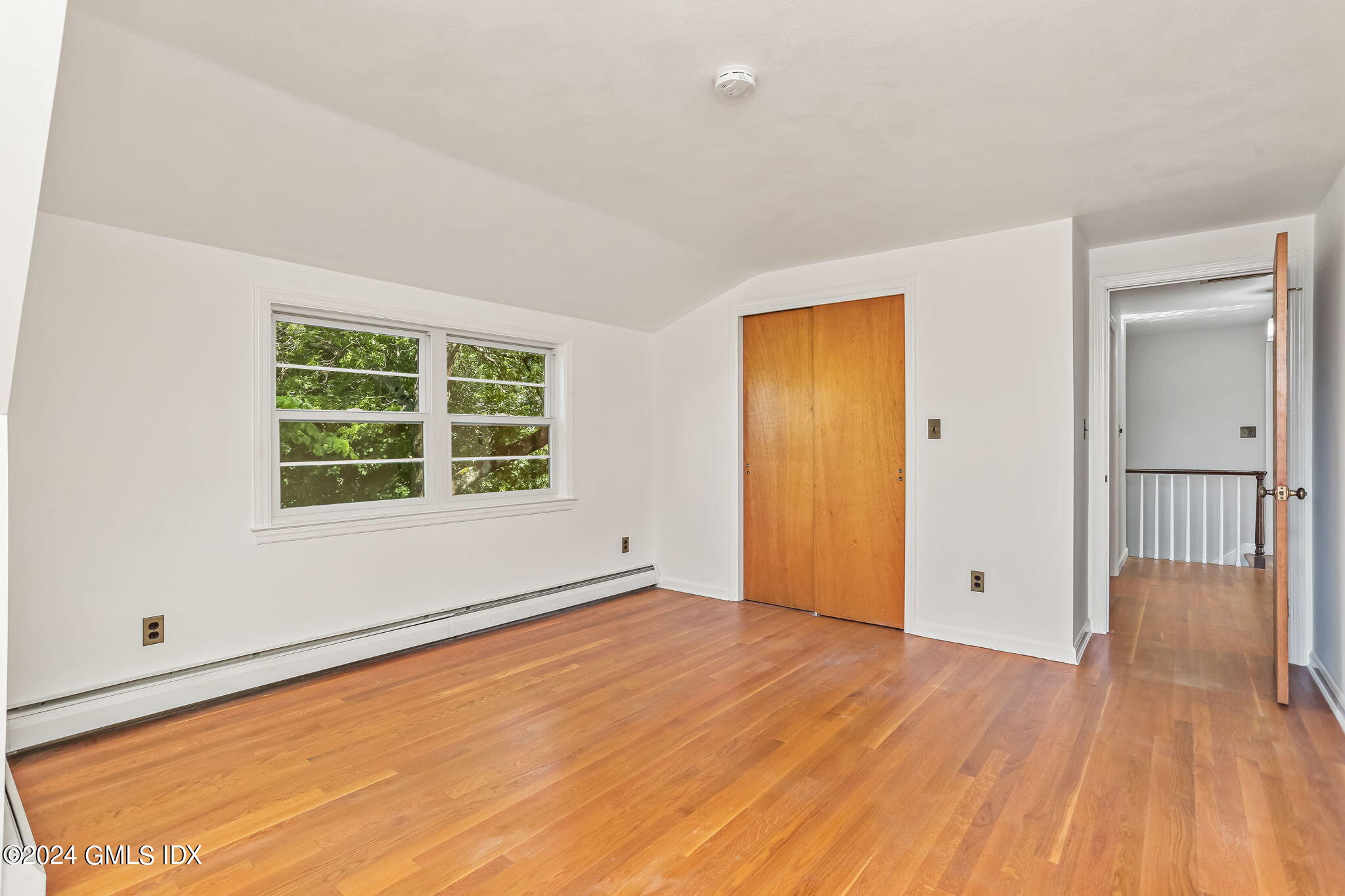 38 Maplewood Drive Cos Cob, CT 06807 - Photo 16 of 24 a view of an empty room with wooden floor and a window
