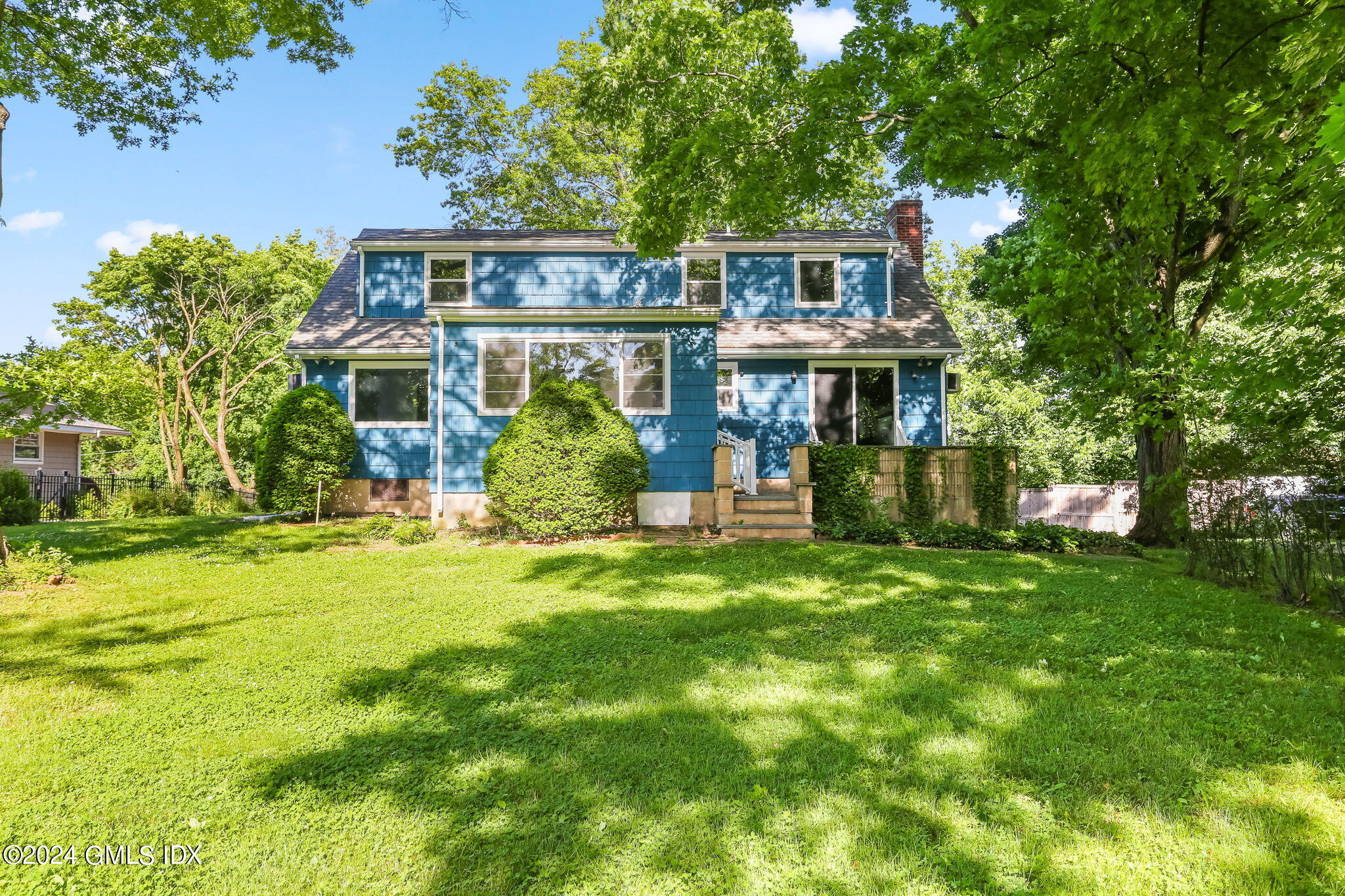 38 Maplewood Drive Cos Cob, CT 06807 - Photo 18 of 24 front view of a house with a big yard