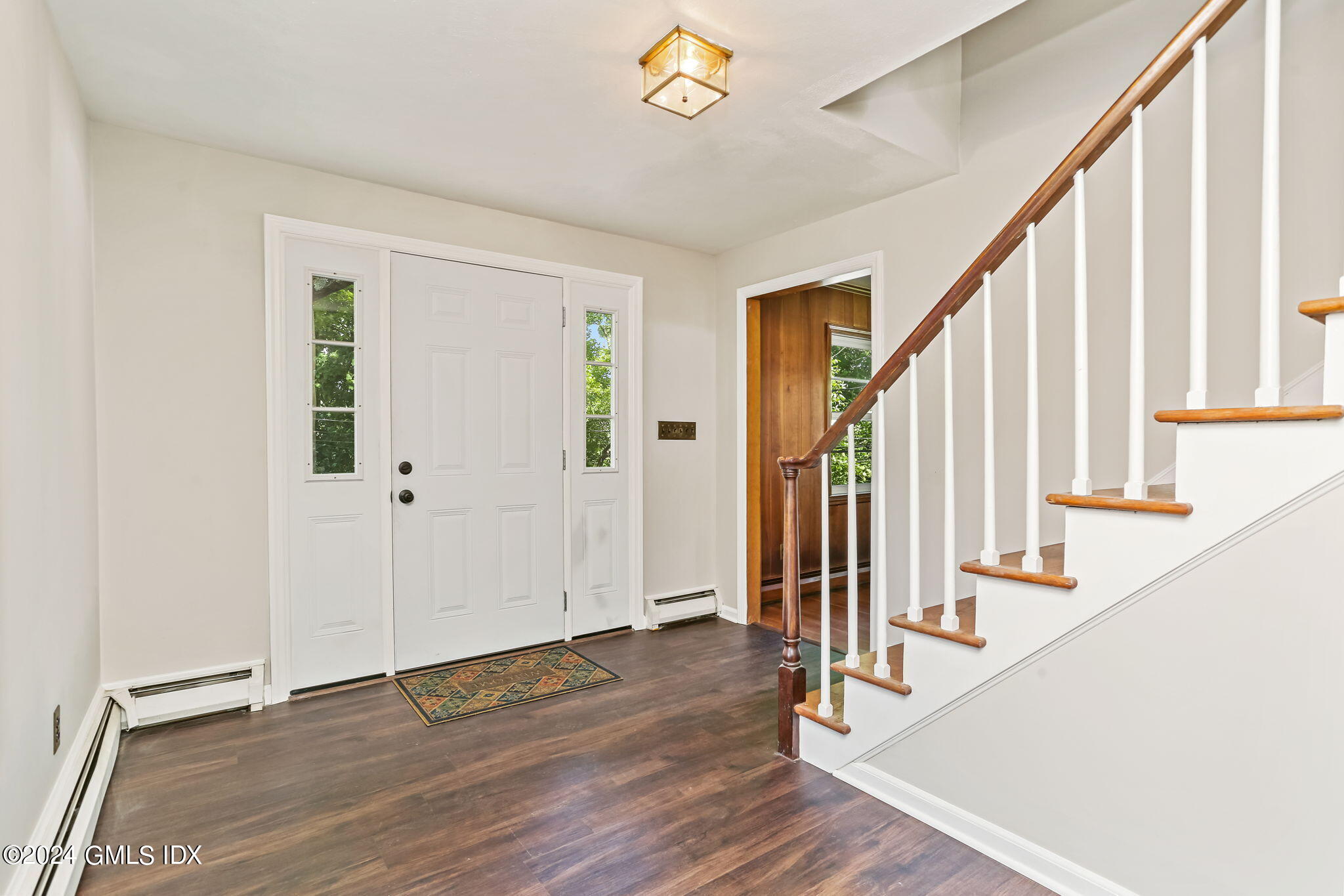 38 Maplewood Drive Cos Cob, CT 06807 - Photo 3 of 24 a view of an entryway with wooden floor and door