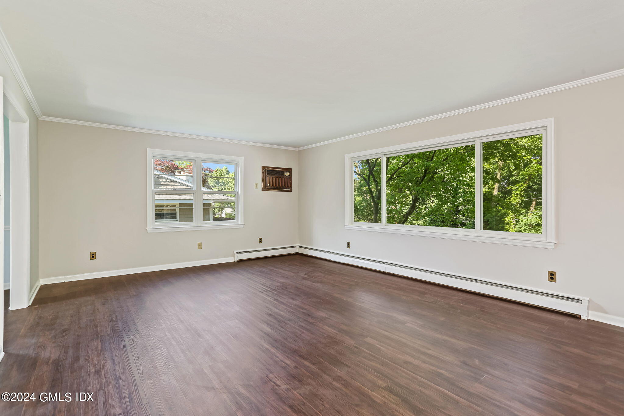 38 Maplewood Drive Cos Cob, CT 06807 - Photo 4 of 24 an empty room with wooden floor and windows