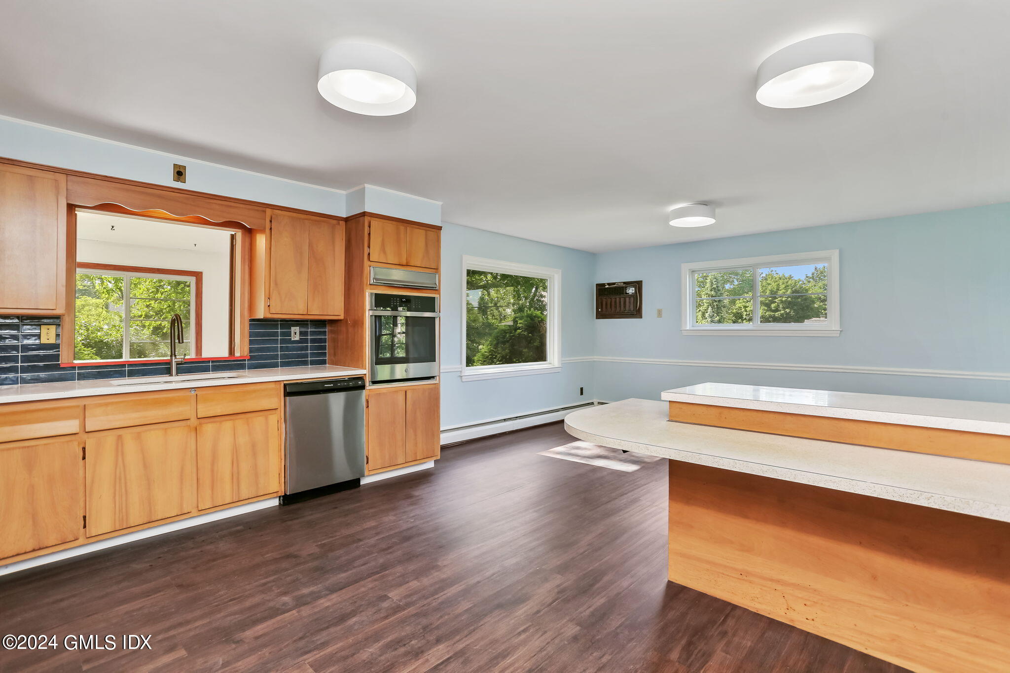 38 Maplewood Drive Cos Cob, CT 06807 - Photo 6 of 24 a kitchen with stainless steel appliances granite countertop a stove a sink and a large window