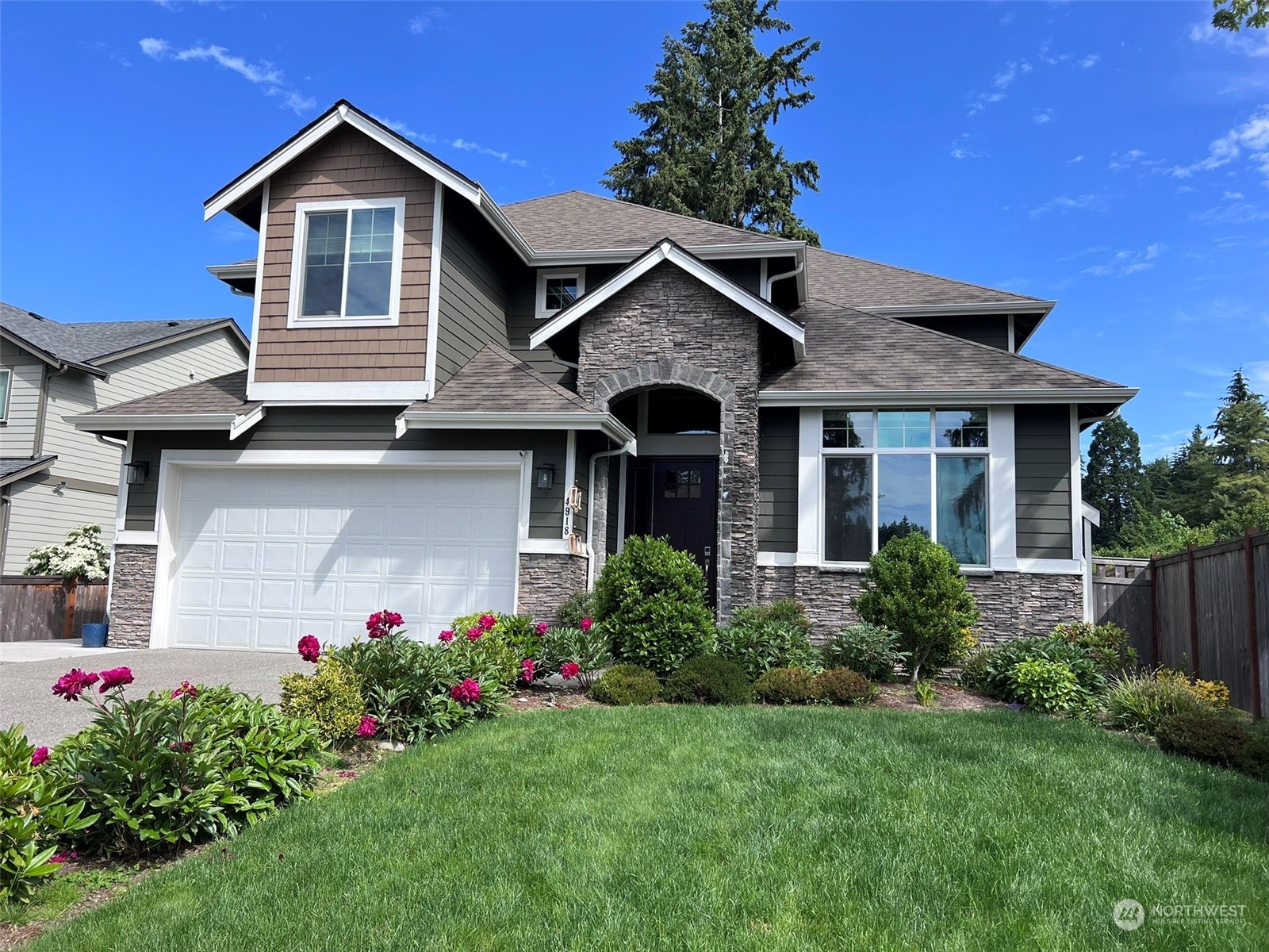 4918 Northeast 1st Street Renton, WA 98059 - Photo 1 of 40 a front view of a house with a yard