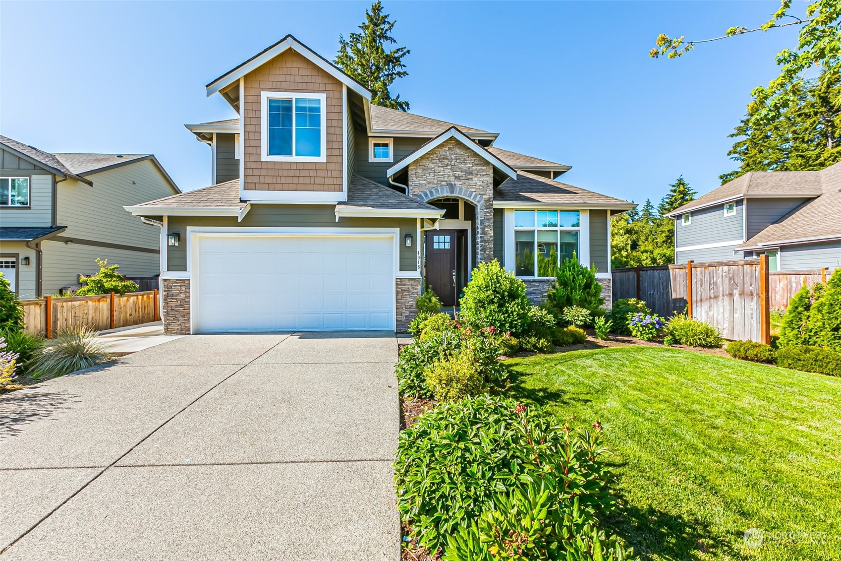4918 Northeast 1st Street Renton, WA 98059 - Photo 2 of 40 a front view of a house with a yard and potted plants