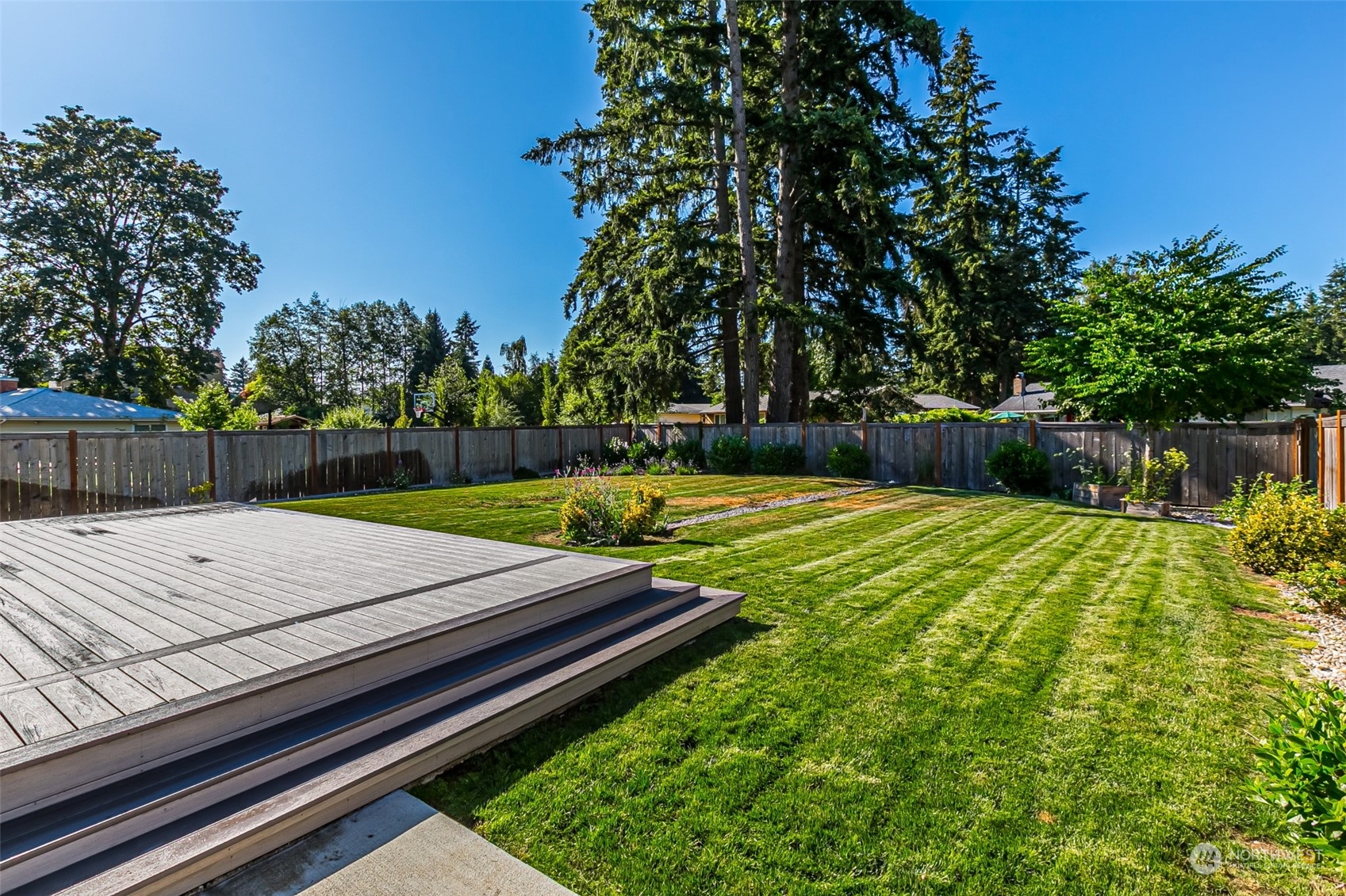 4918 Northeast 1st Street Renton, WA 98059 - Photo 40 of 40 a view of a backyard with a wooden fence