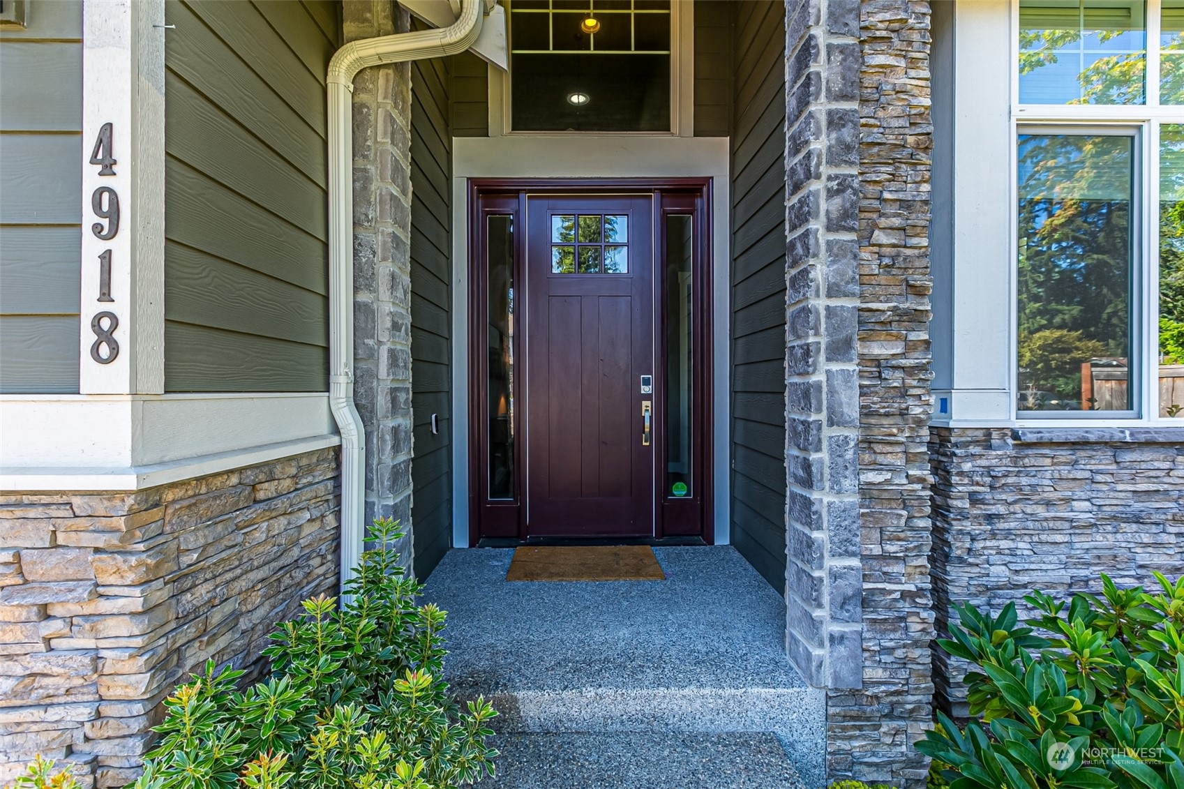 4918 Northeast 1st Street Renton, WA 98059 - Photo 4 of 40 a front view of a house with a glass door