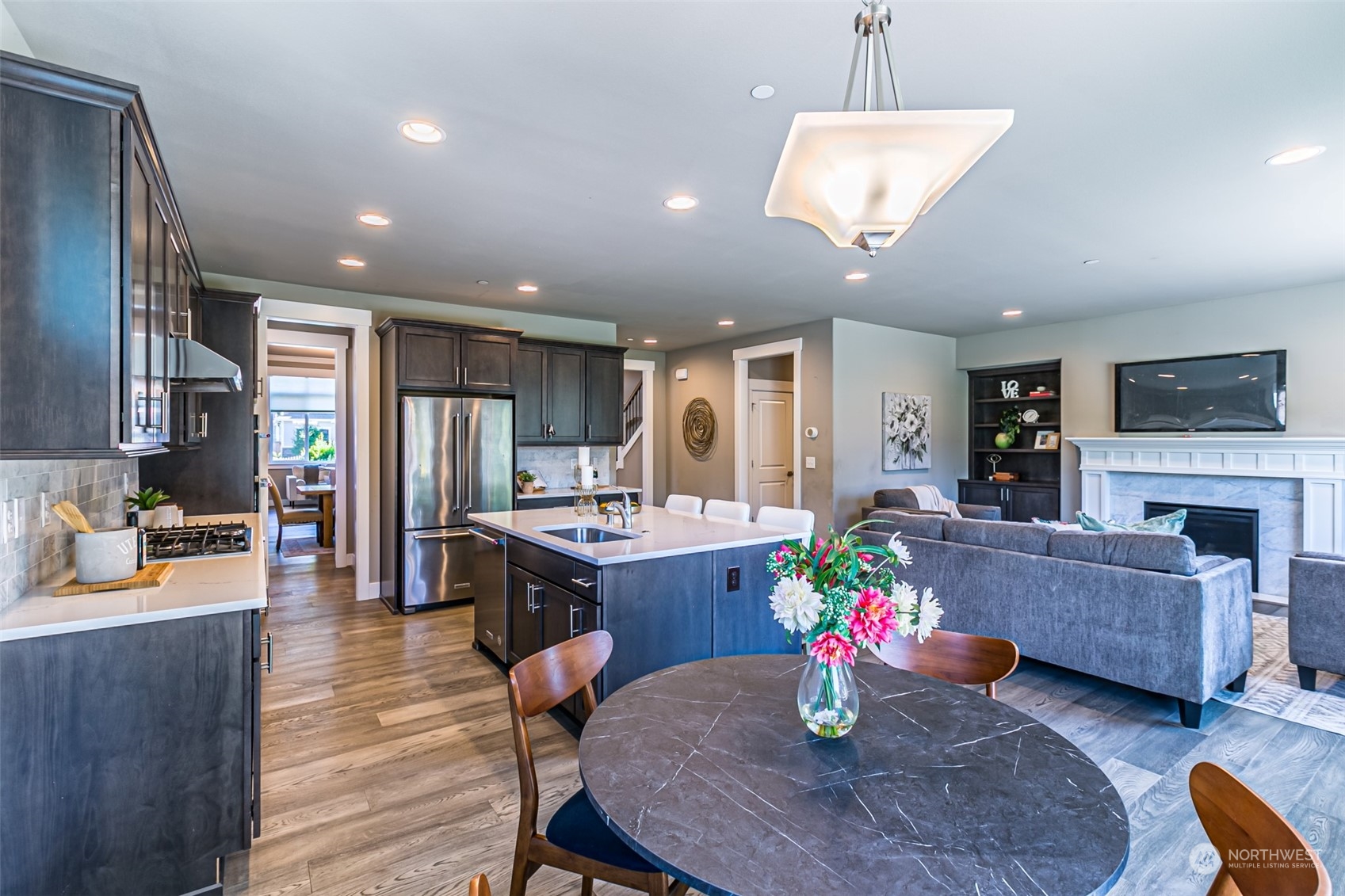 4918 Northeast 1st Street Renton, WA 98059 - Photo 7 of 40 a kitchen with microwave a dining table and chairs