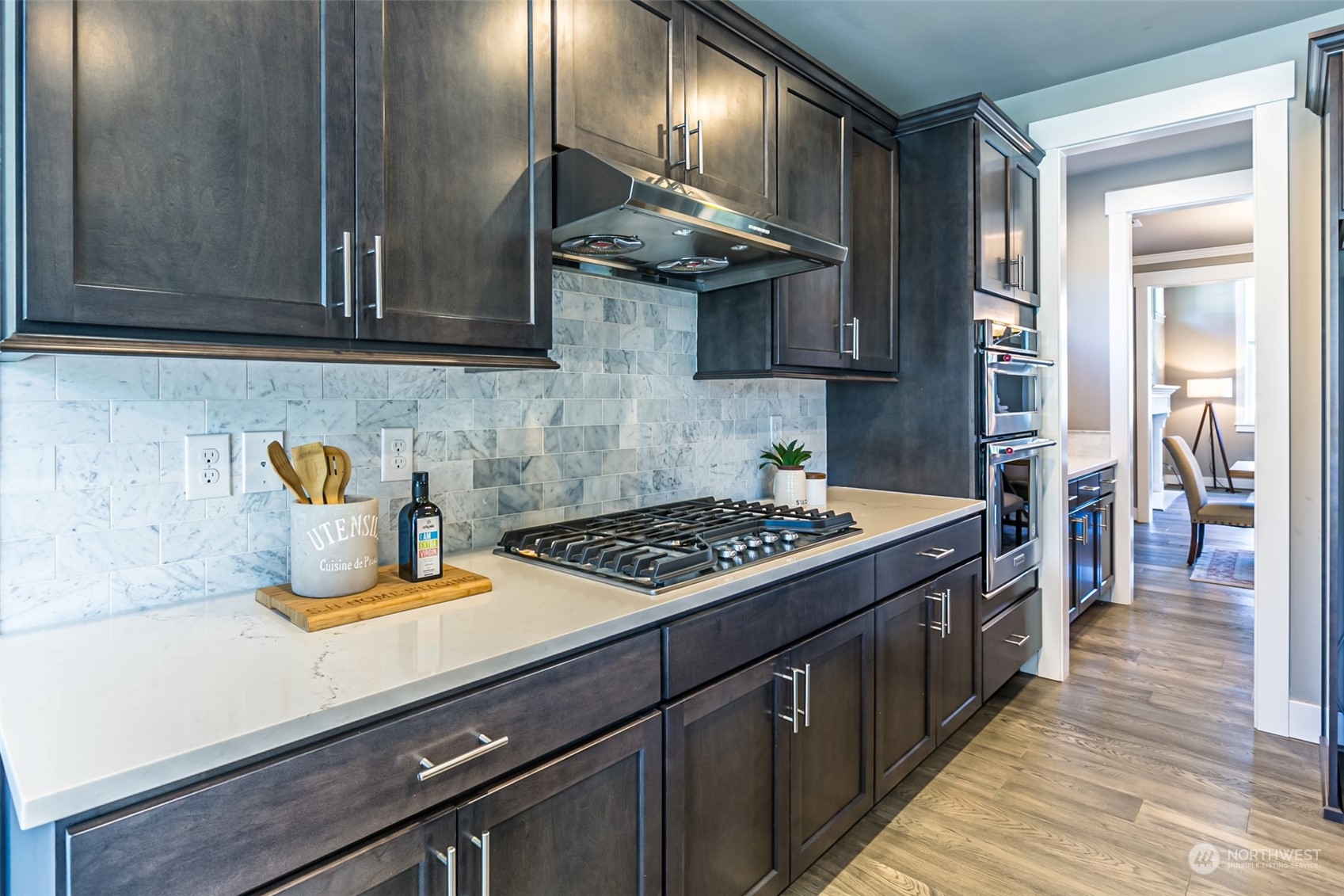 4918 Northeast 1st Street Renton, WA 98059 - Photo 9 of 40 a kitchen with stainless steel appliances granite countertop a stove a sink and a microwave