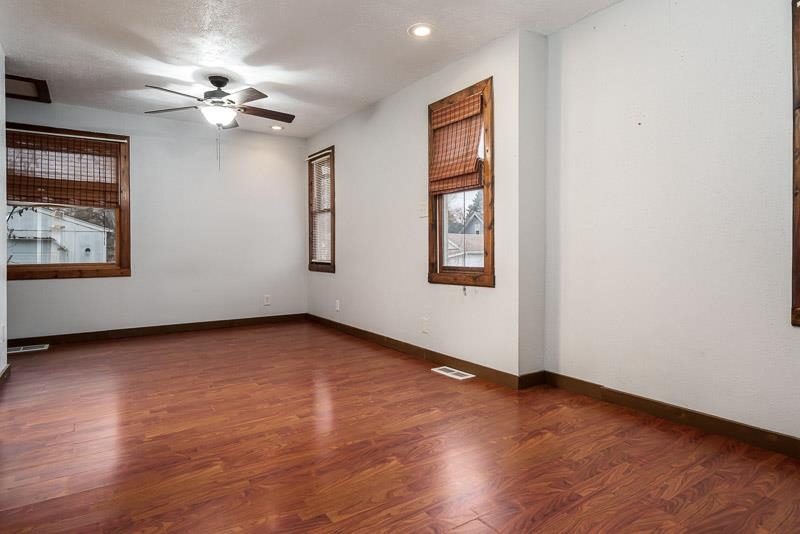 207 River Park Road Loves Park, IL 61111 - Photo 21 of 41 a view of an empty room with wooden floor and a window