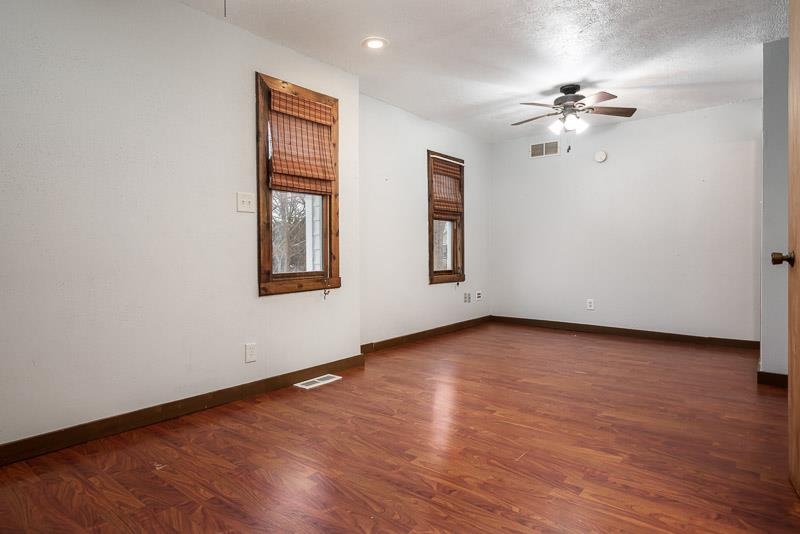 207 River Park Road Loves Park, IL 61111 - Photo 23 of 41 a view of an empty room with wooden floor and a window