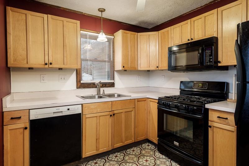 207 River Park Road Loves Park, IL 61111 - Photo 25 of 41 a kitchen with stainless steel appliances granite countertop a stove a sink and a microwave