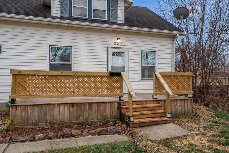 207 River Park Road Loves Park, IL 61111 - Photo 3 of 41 a front view of a house with a garden