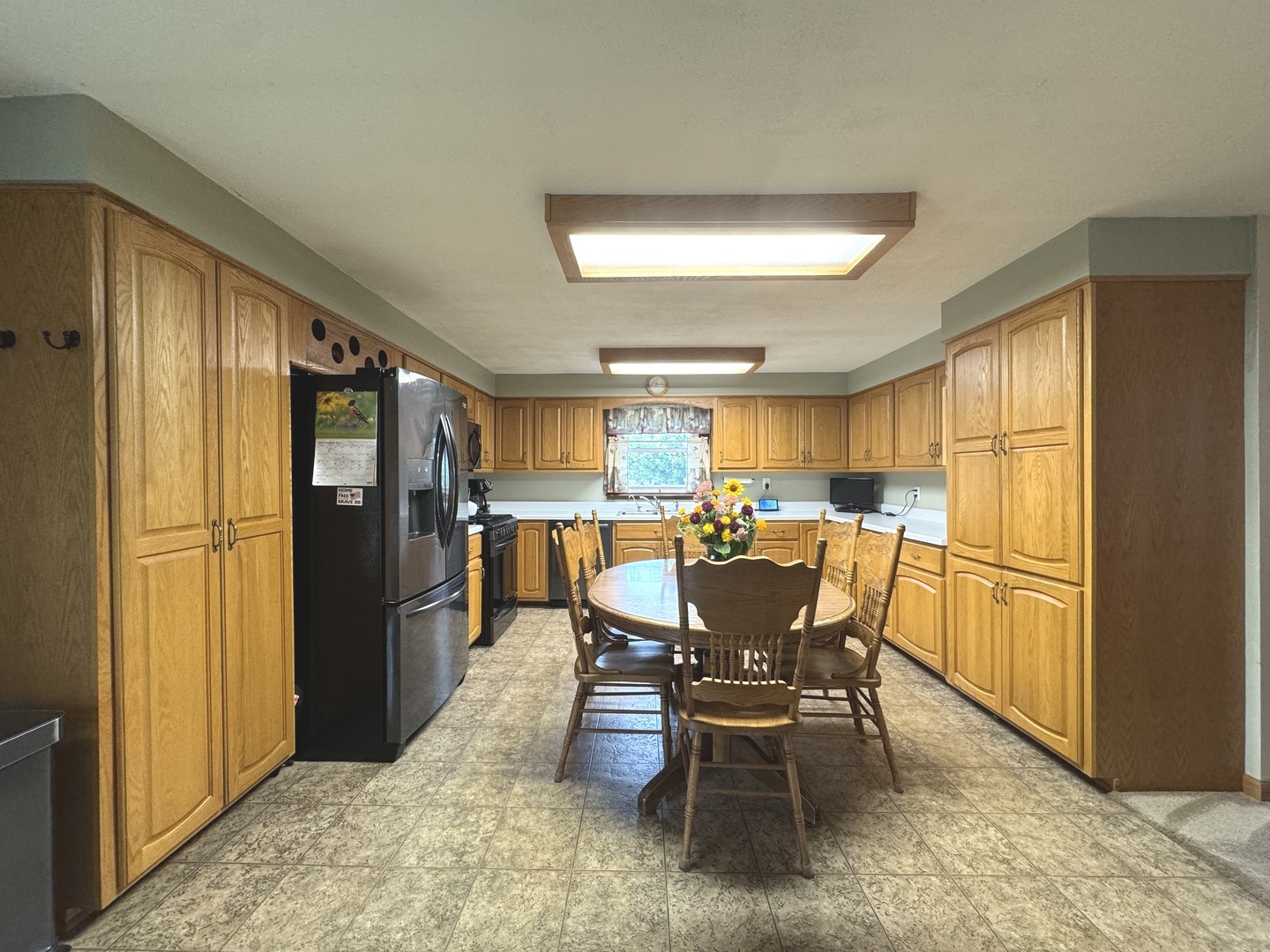 5382 South 2000W Road Chebanse, IL 60922 - Photo 12 of 54 a dining room with furniture a kitchen view and a refrigerator