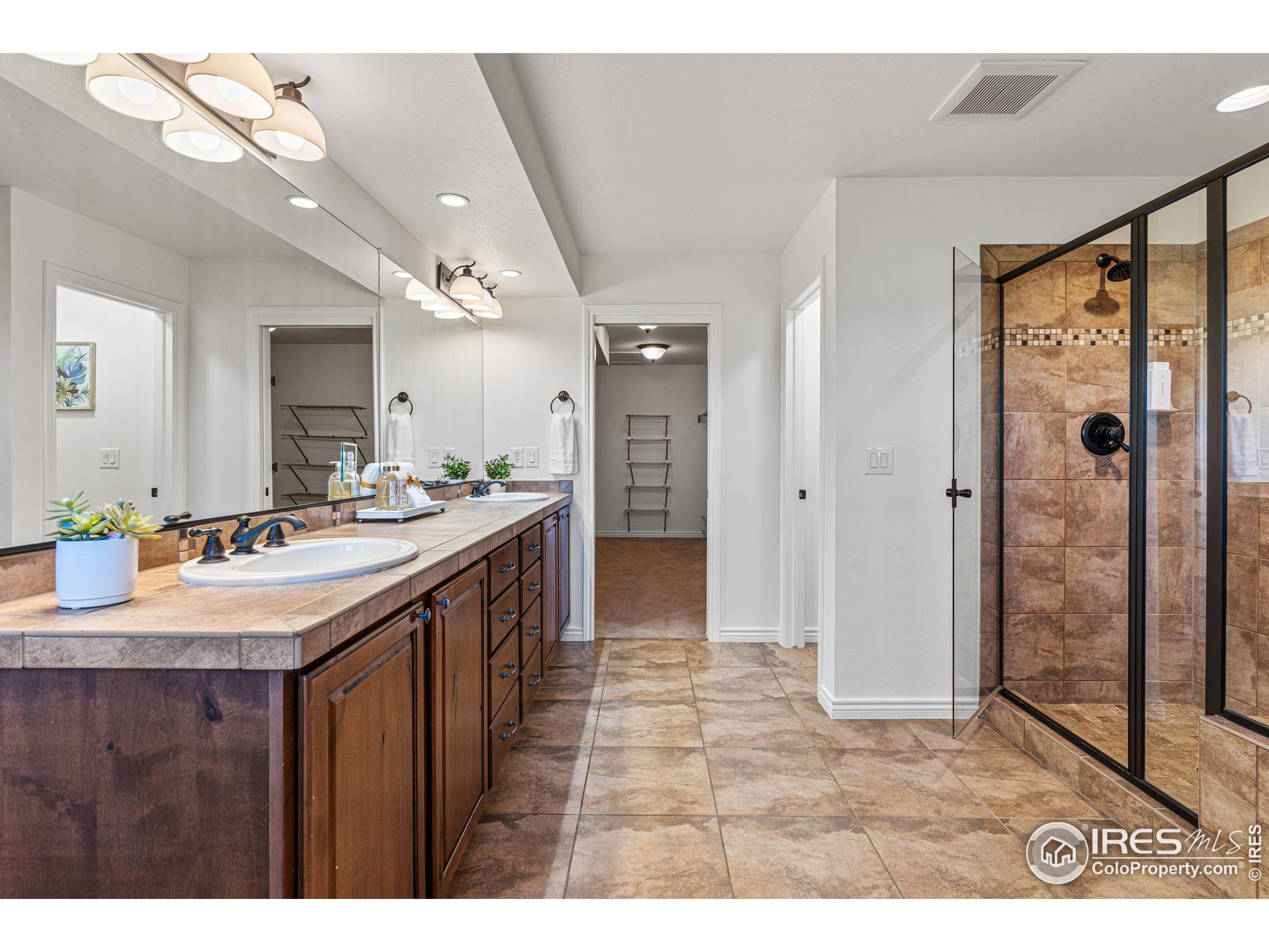 3766 Ridgeway Street Boulder, CO 80301 - Photo 28 of 42 a bathroom with a sink a toilet a mirror and shower