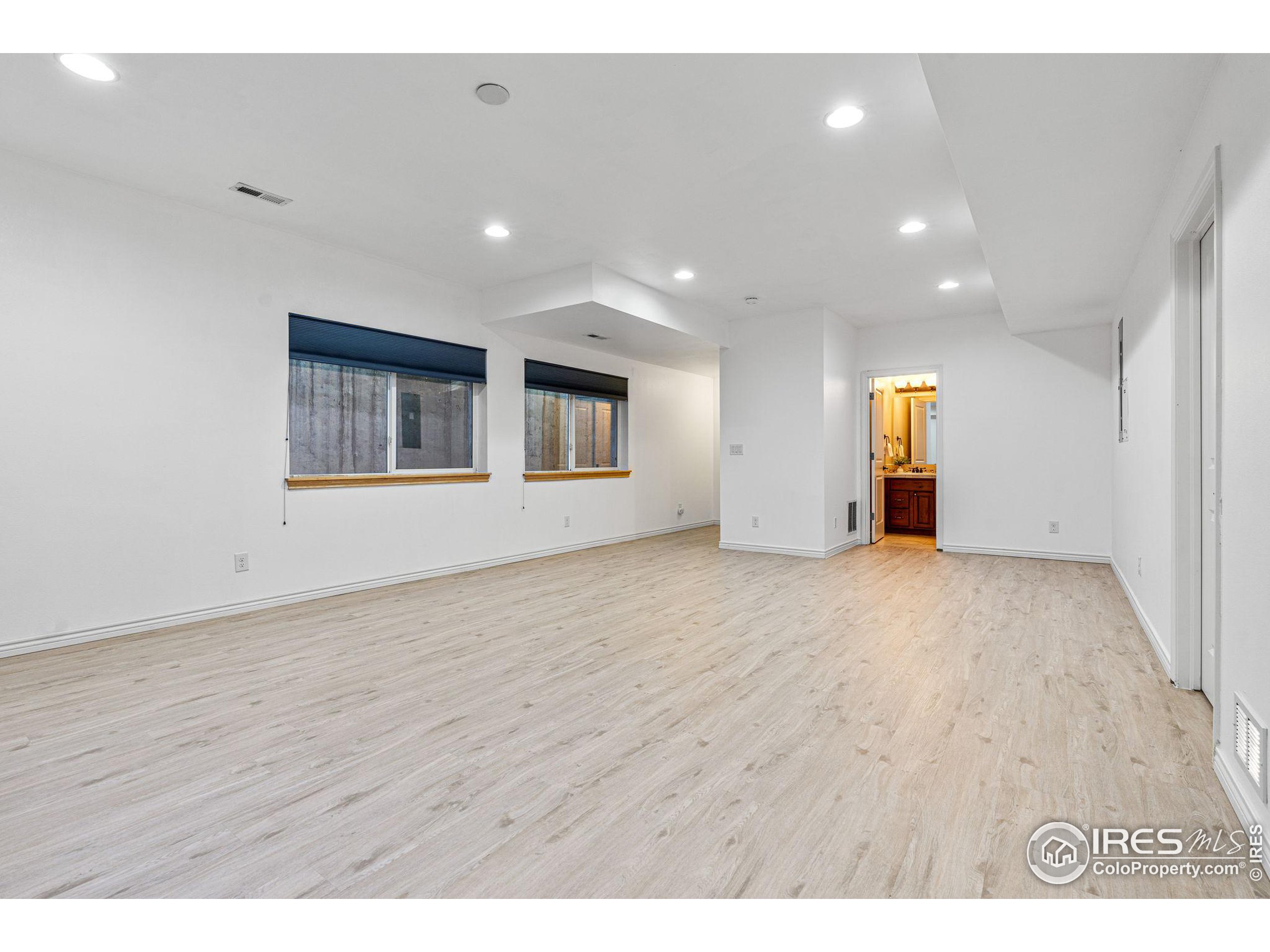 3766 Ridgeway Street Boulder, CO 80301 - Photo 39 of 42 a view of an empty room with wooden floor and windows