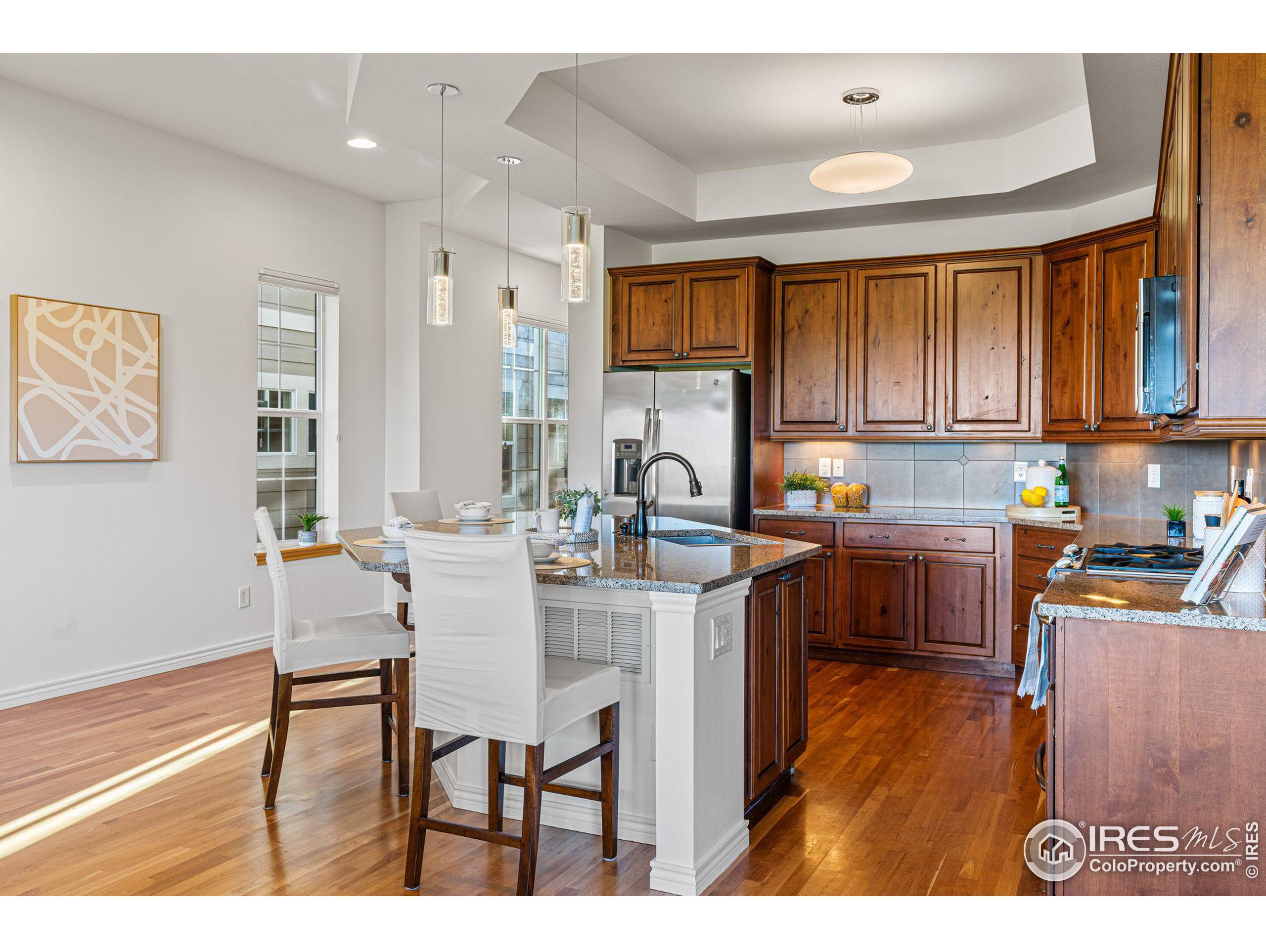 3766 Ridgeway Street Boulder, CO 80301 - Photo 9 of 42 a kitchen with a table chairs refrigerator and cabinets
