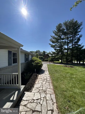 a view of a pathway with a yard